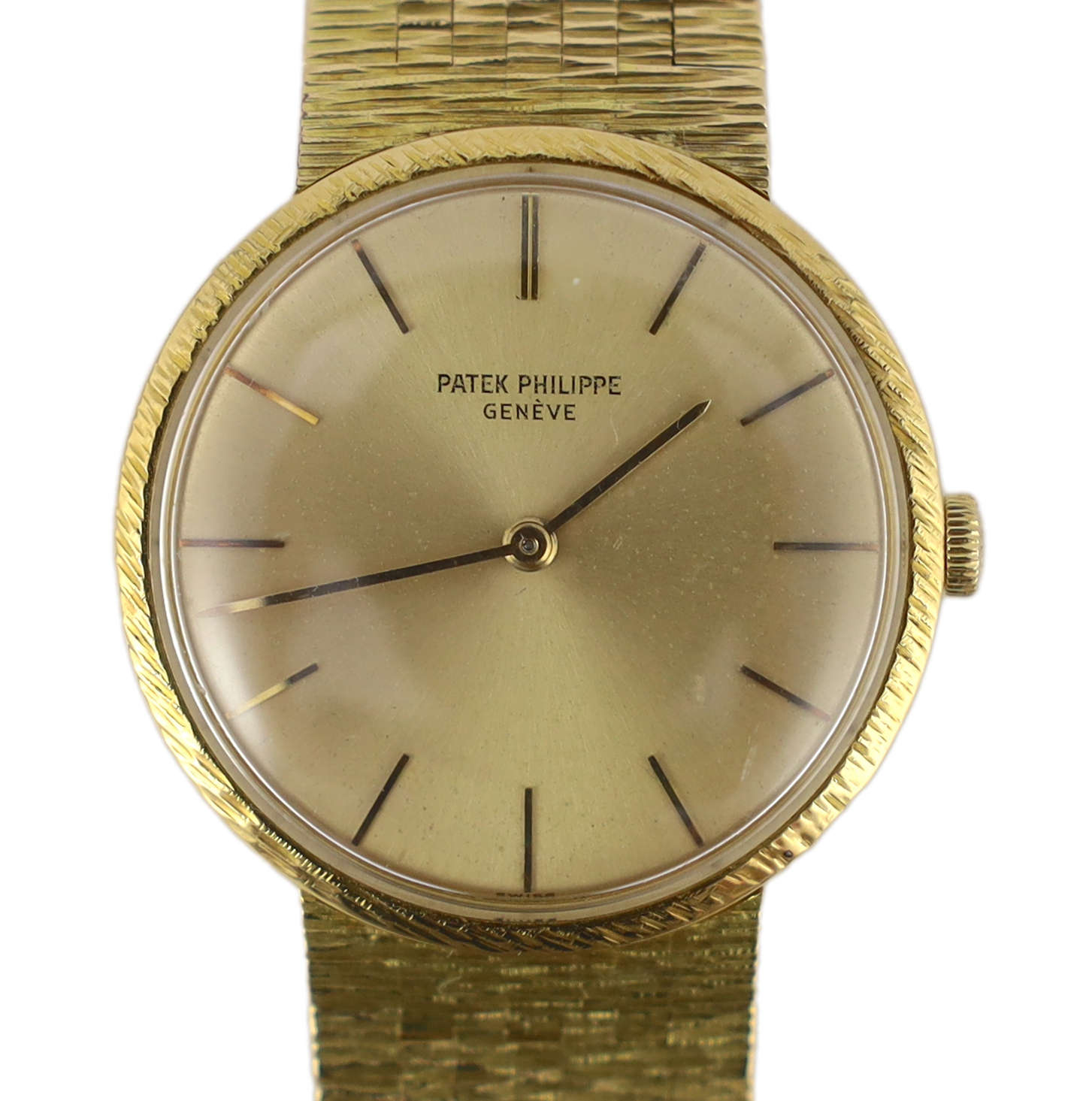 A gentleman's 18ct gold Patek Philippe Calatrava manual wind wrist watch, on an integral Patek Philippe 18ct gold bark bracelet